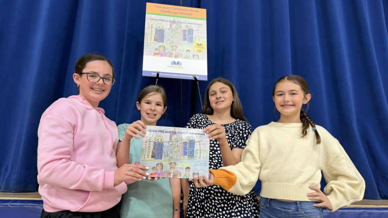 Group winners holding book
